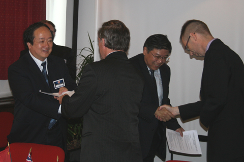 hand shakes after signing Coupe Mondiale 2011 contract